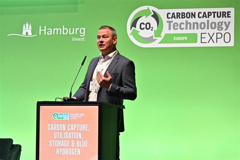 Man on stage presenting for Carbon Capture Conference