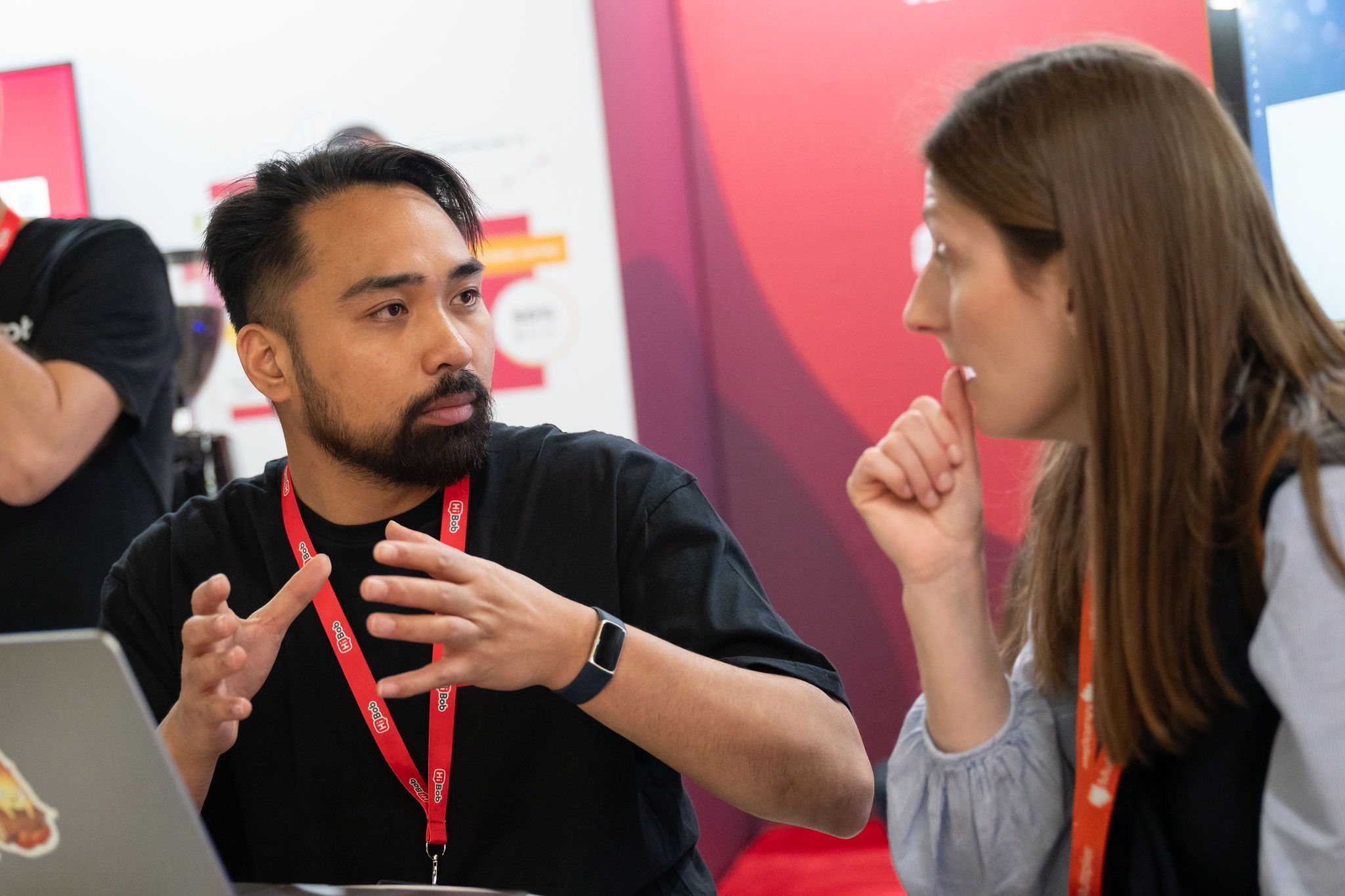 Visitors communicating with an exhibitor on their stand at HR Technologies UK