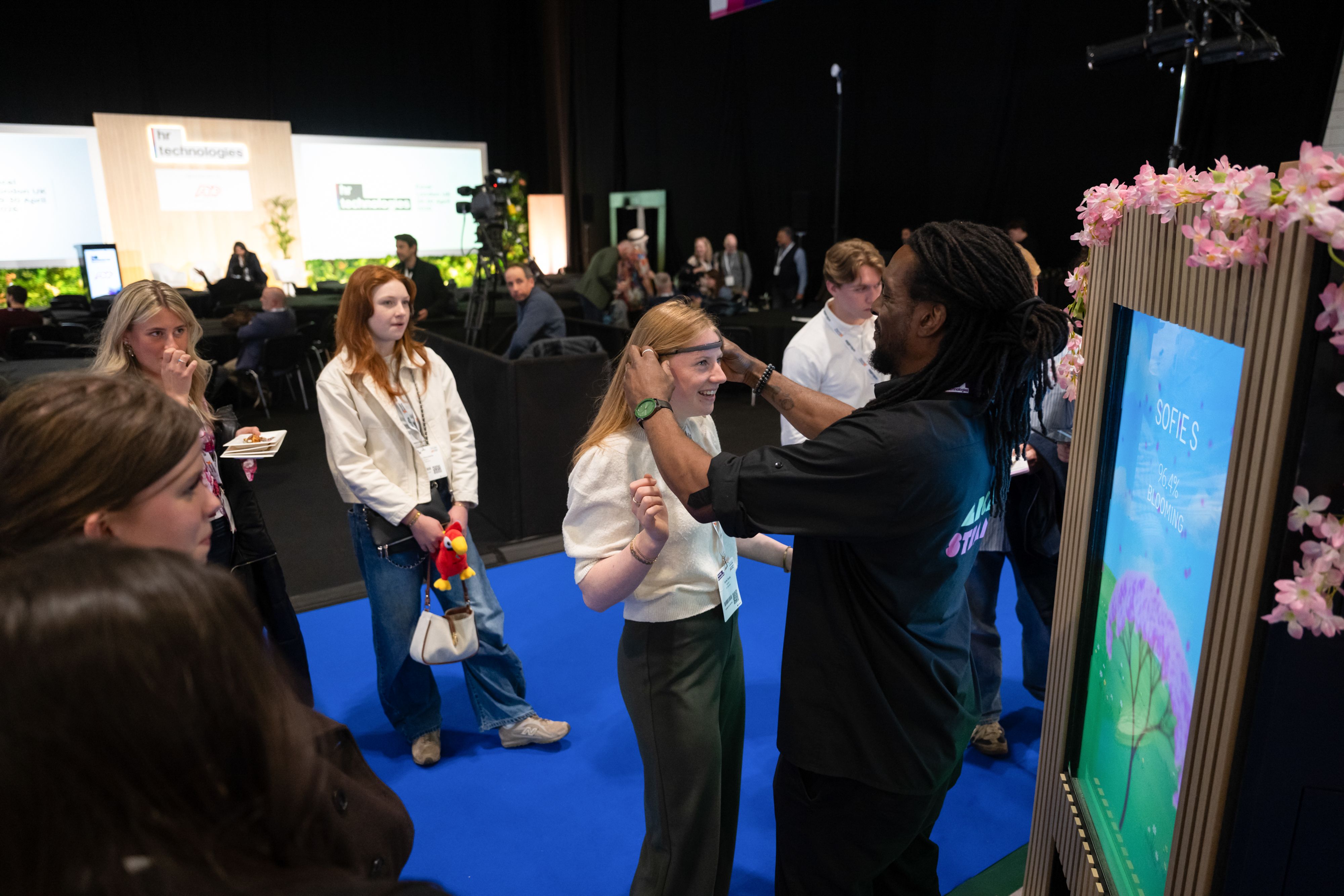 A visitor trying out a tech-based game on an exhibitor's stand at HR Technologies UK