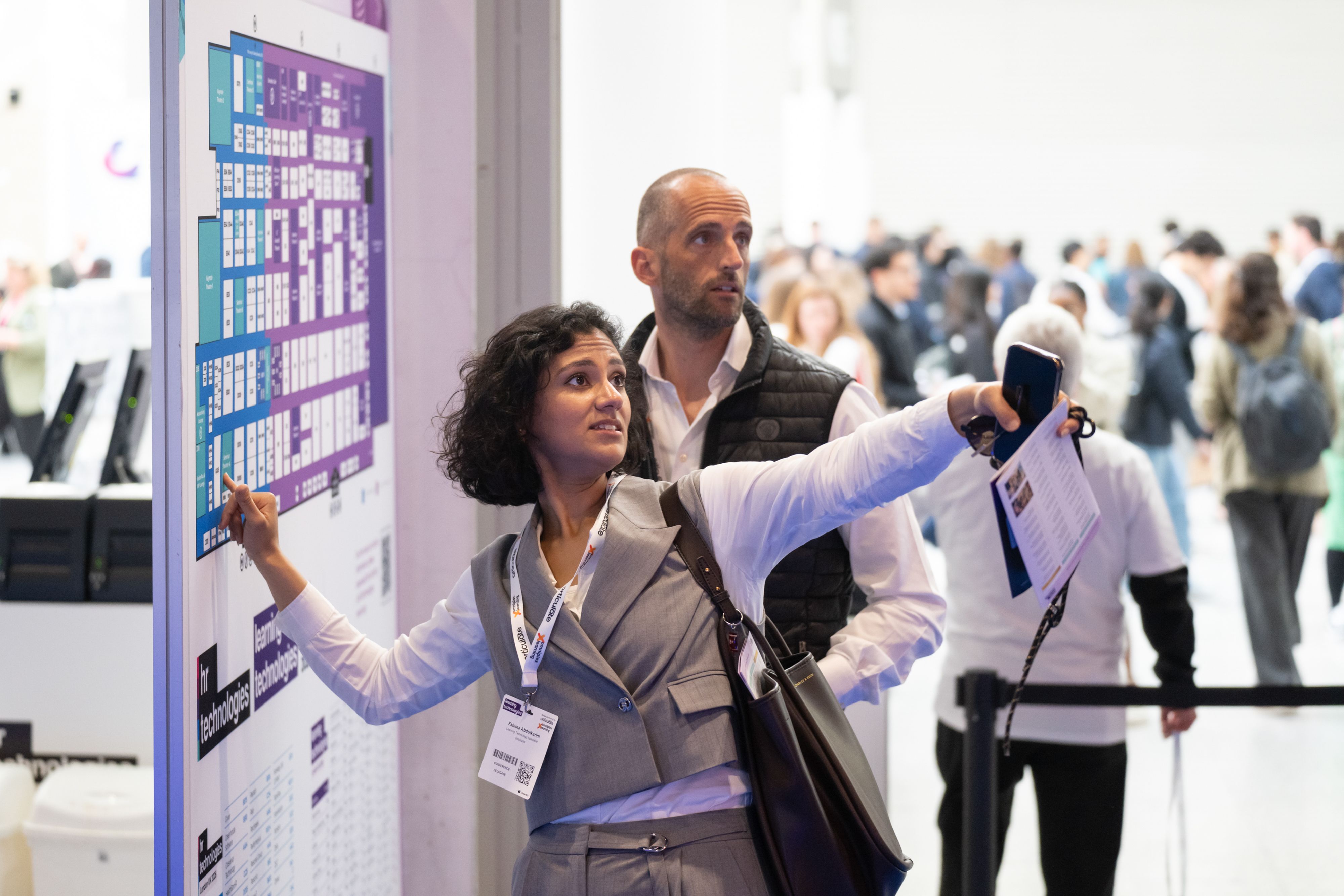Visitors looking at the floor plan of HR Technologies UK and Learning Technologies UK