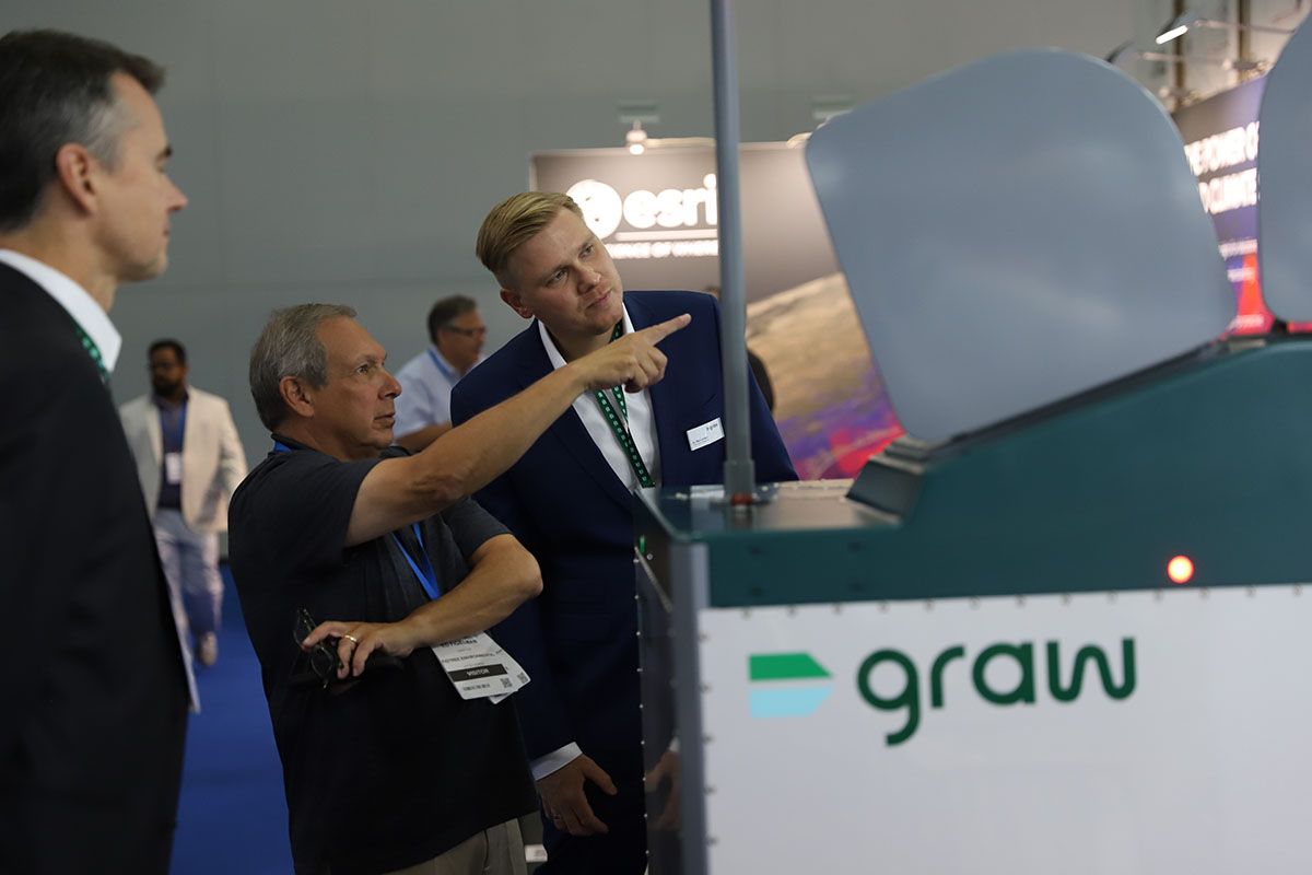 Photo shows two people deep in discussion about the tech on display at Met Tech World Expo