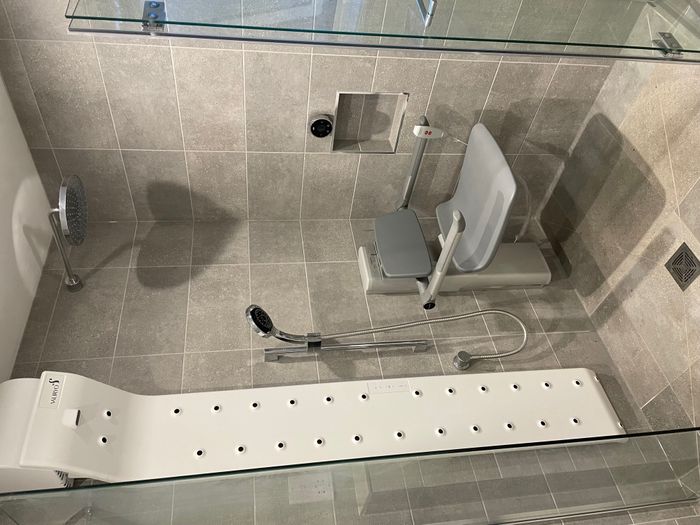 Powered shower seat