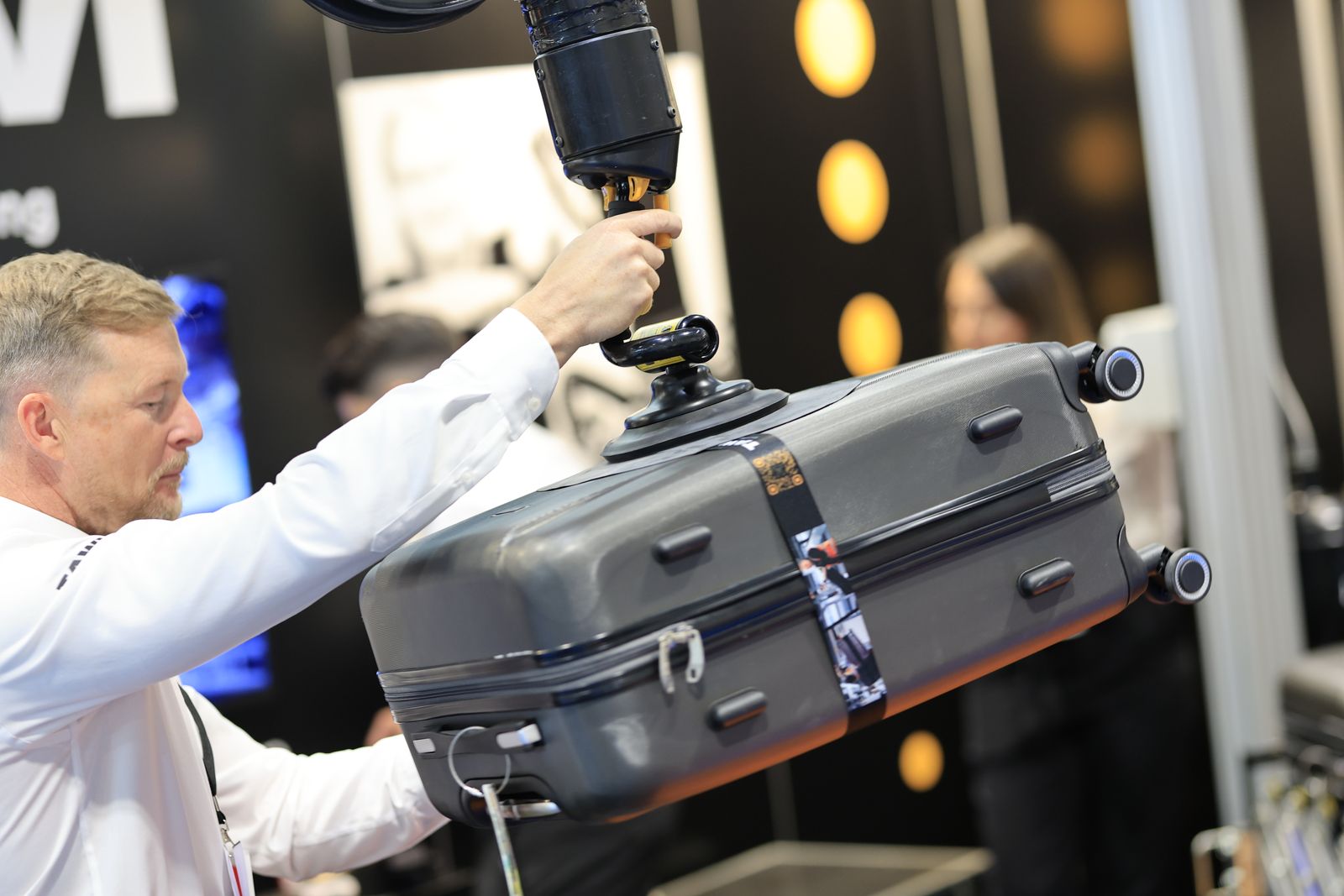 Exhibitor demonstrating baggage handling equipment