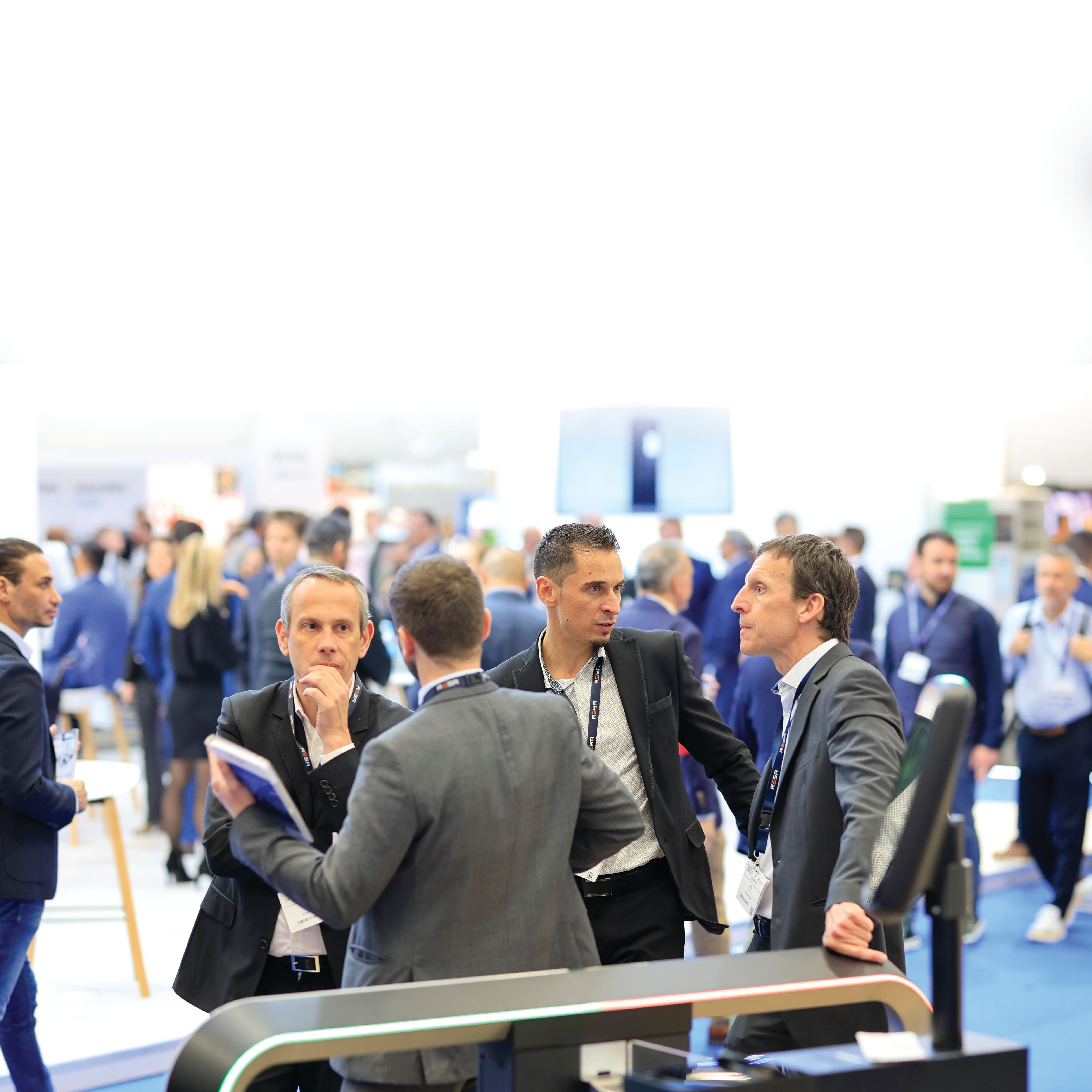 Exhibitors and visitors discussing business PTE World