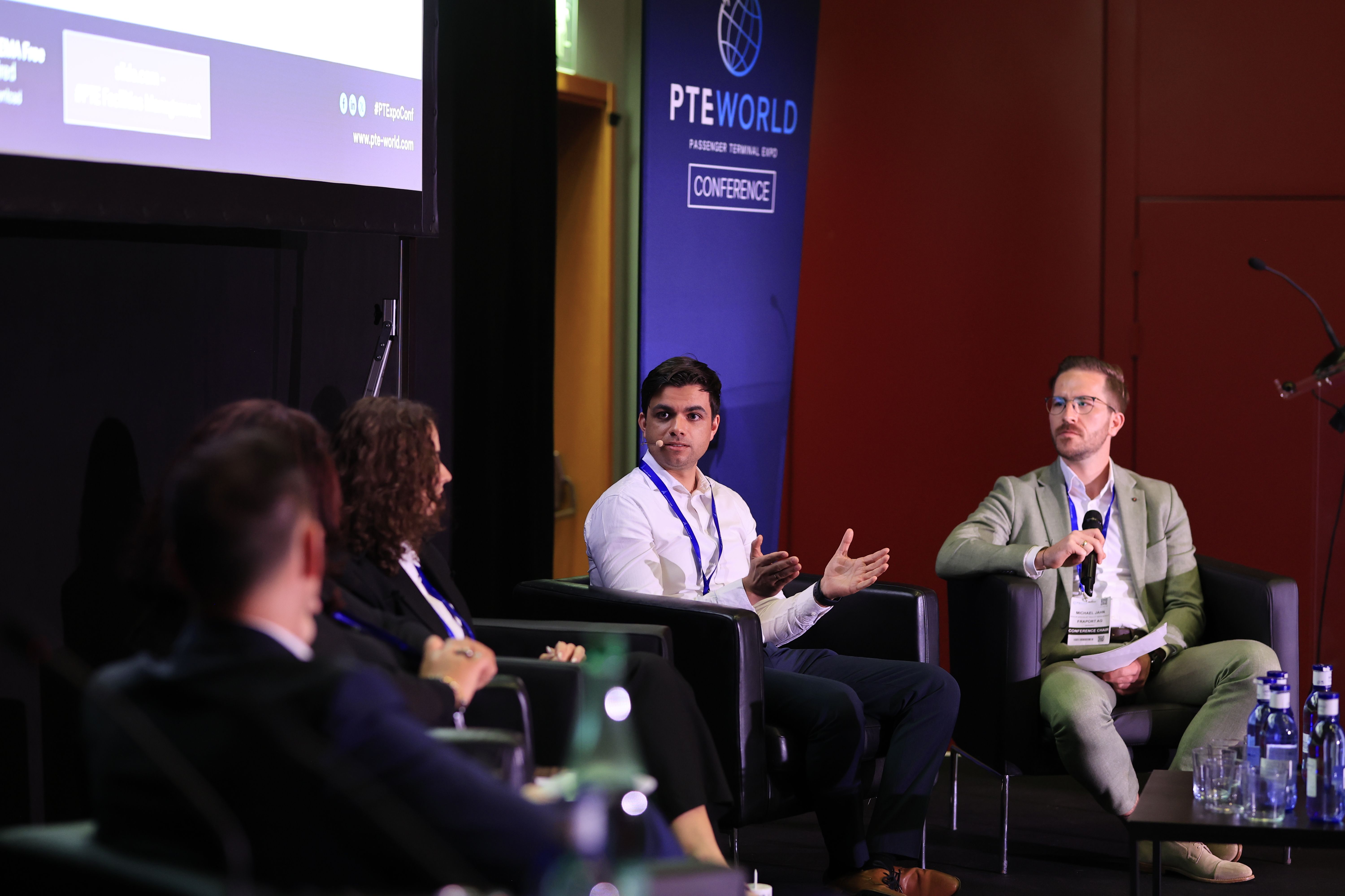 Photo shows speaker on stage at PTE World Conference