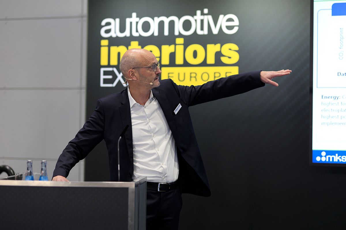 Photo shows a speaker at the Automotive Interiors conference