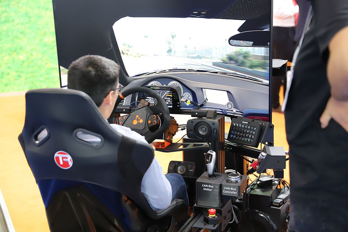 Photo shows a visitor getting a product demo at Automotive Interiors Expo