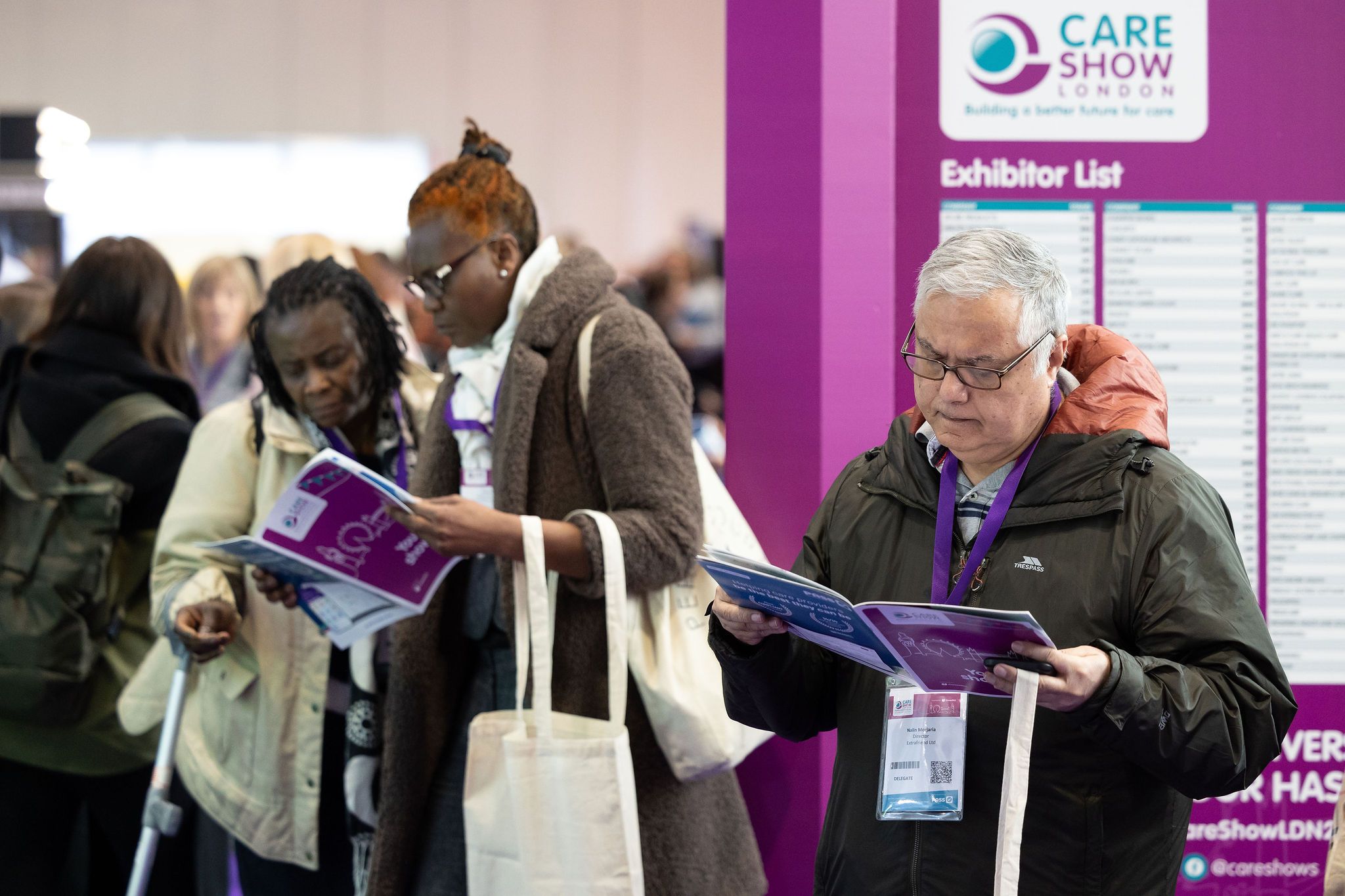 Care Show London - 2 women reading show guide