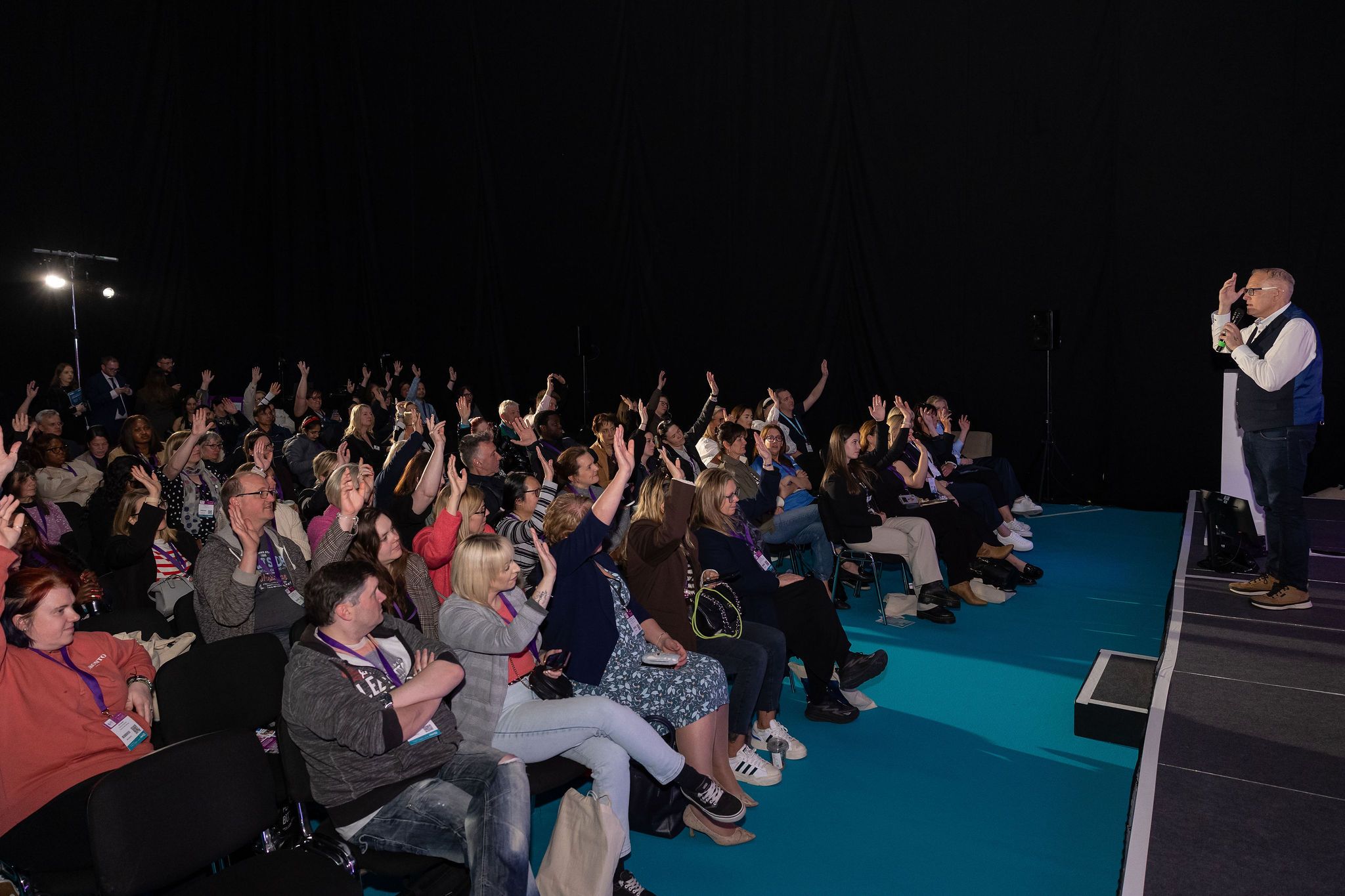 A seminar in the Keynote Theatre - People with their hands up
