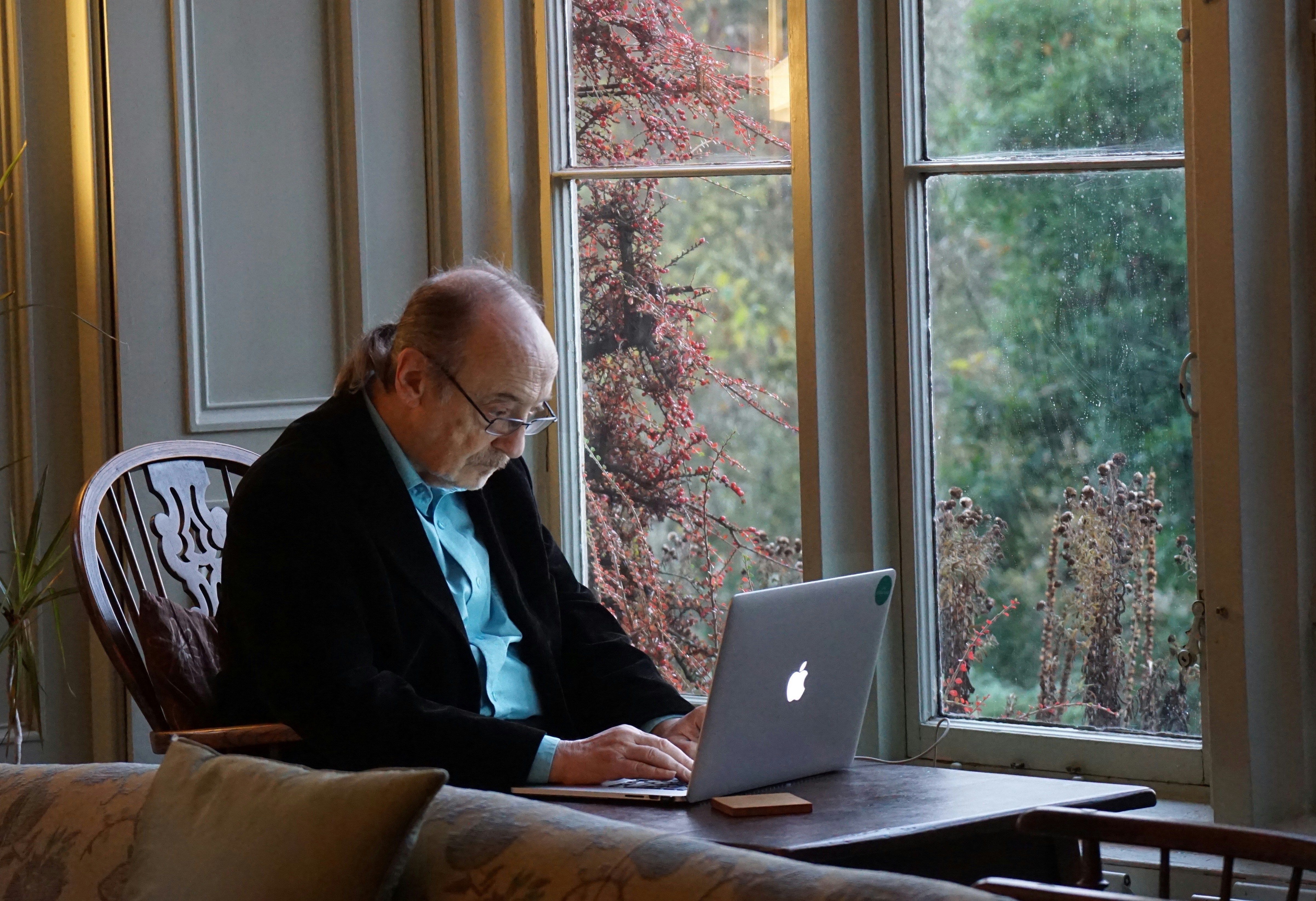 elderly man on a laptop
