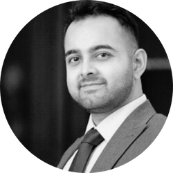 Black and white photo of Ibrar Khalid in a suit 
