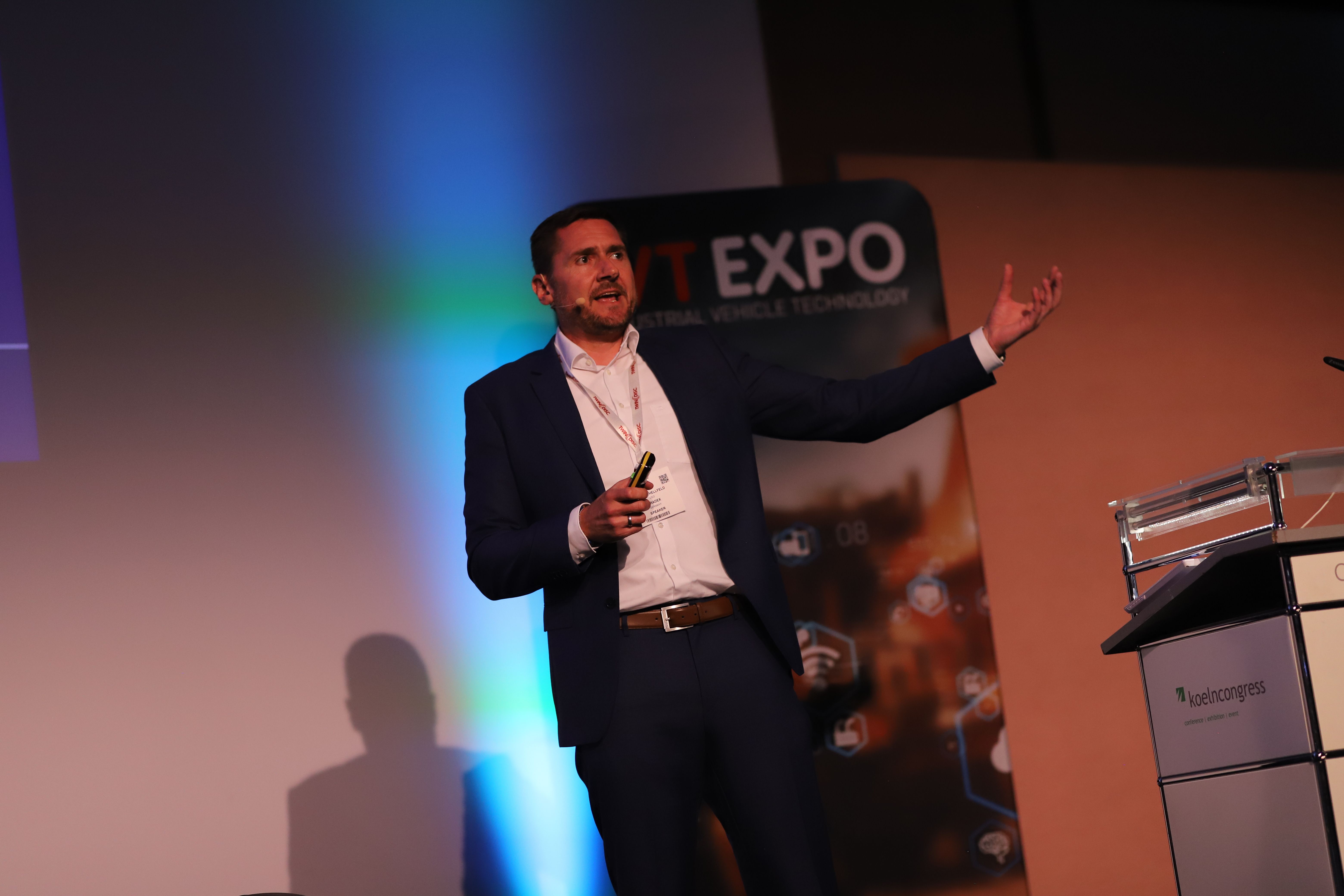 Photo shows male speaker presenting at the Off-Highway Evolution Summit