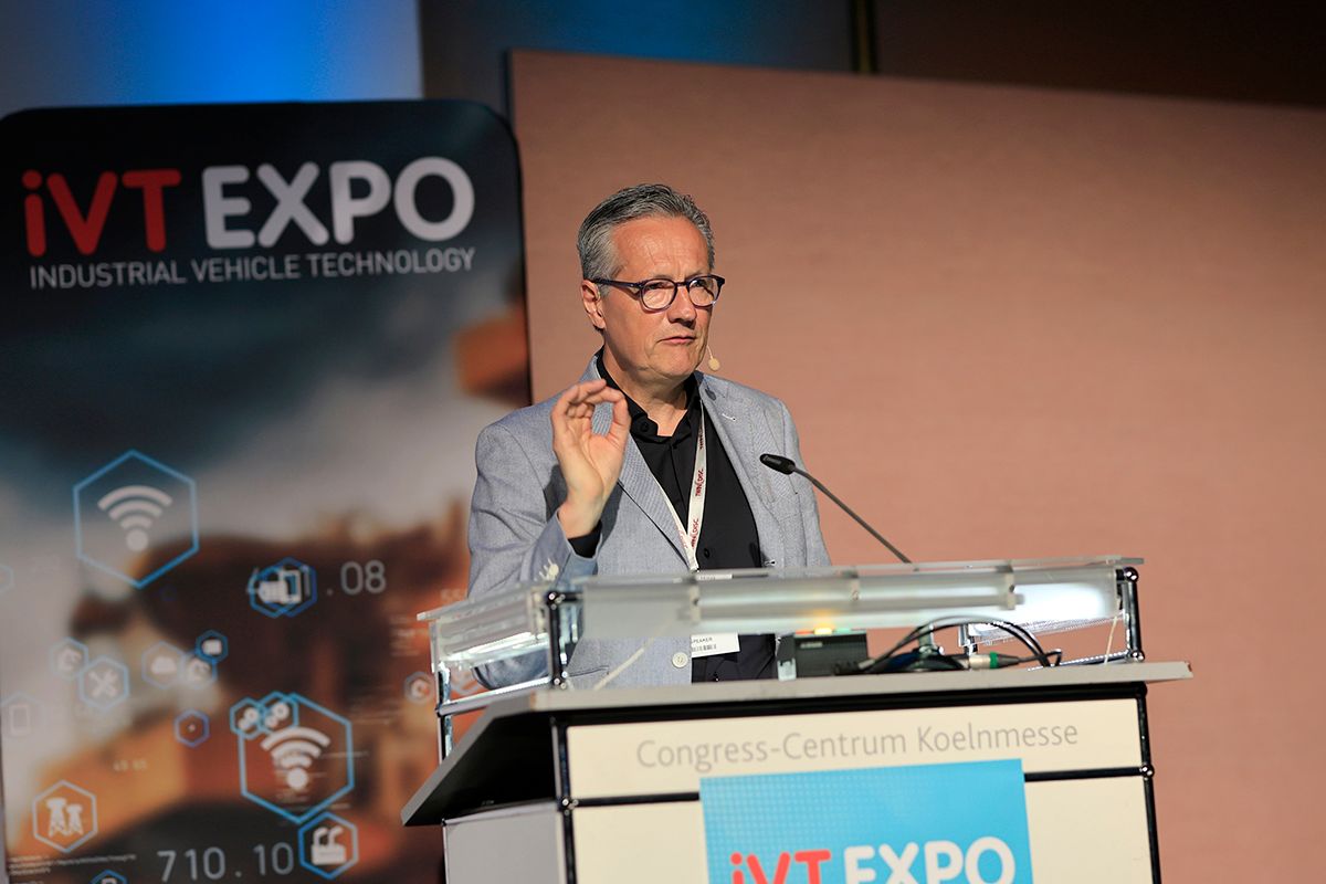 Photo shows a man speaking at the iVT Expo conference