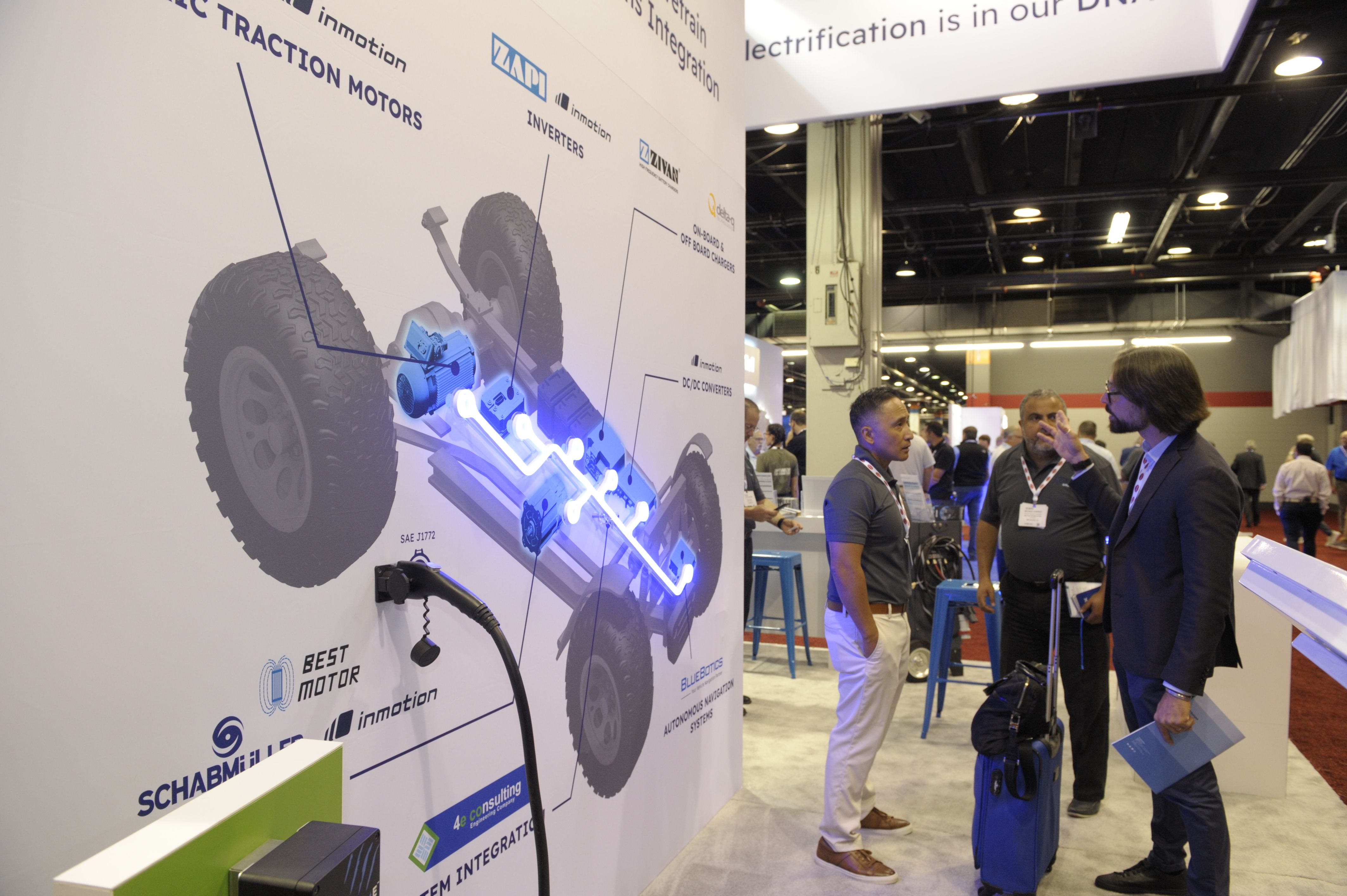 Photo shows an eye-catching exhibit with lights and people networking in the background at iVT Expo