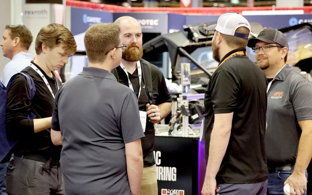 Photo shows a group of attendees networking at iVT Off-Highway Vehicle Technology Expo in Chicago, USA