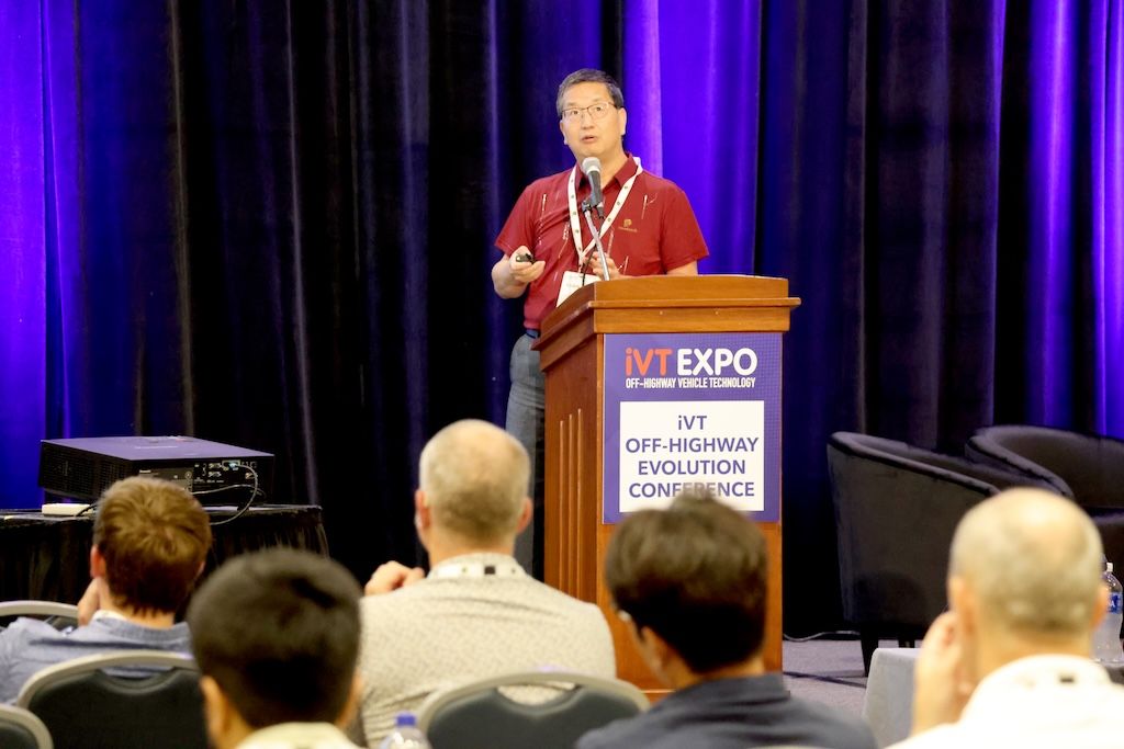 Photo shows a speaker in front of an engaged audience at the Off-Highway Evolution Conference at iVT Expo USA