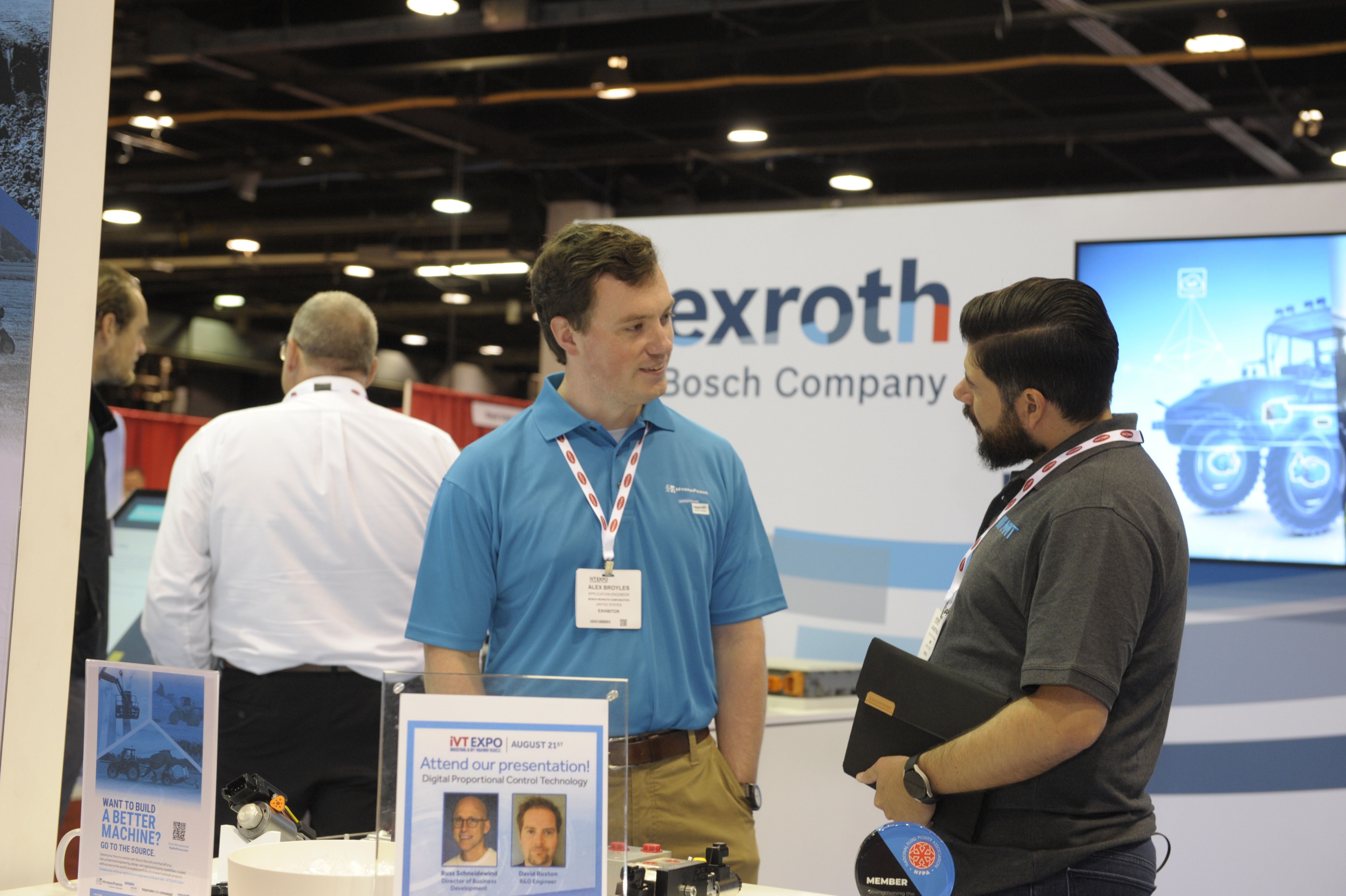 Photo shows an exhibitor and visitor at iVT Expo in Chicago in deep conversation