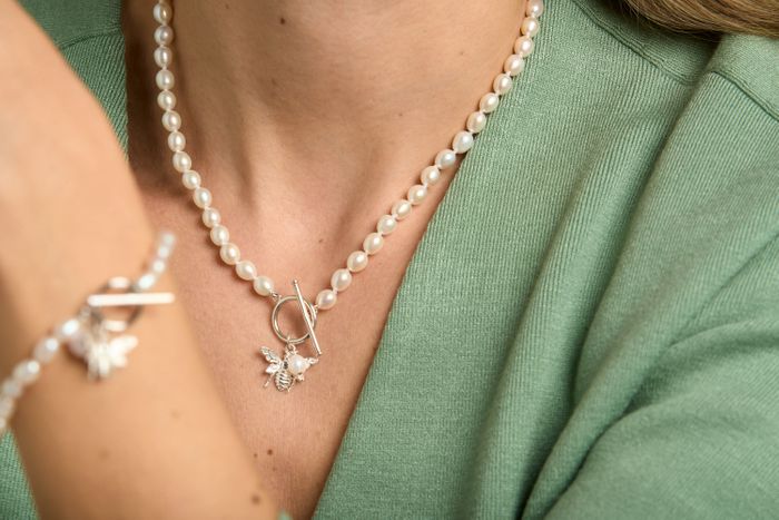 Oval white cultured freshwater pearl set with sterling silver bumble bee