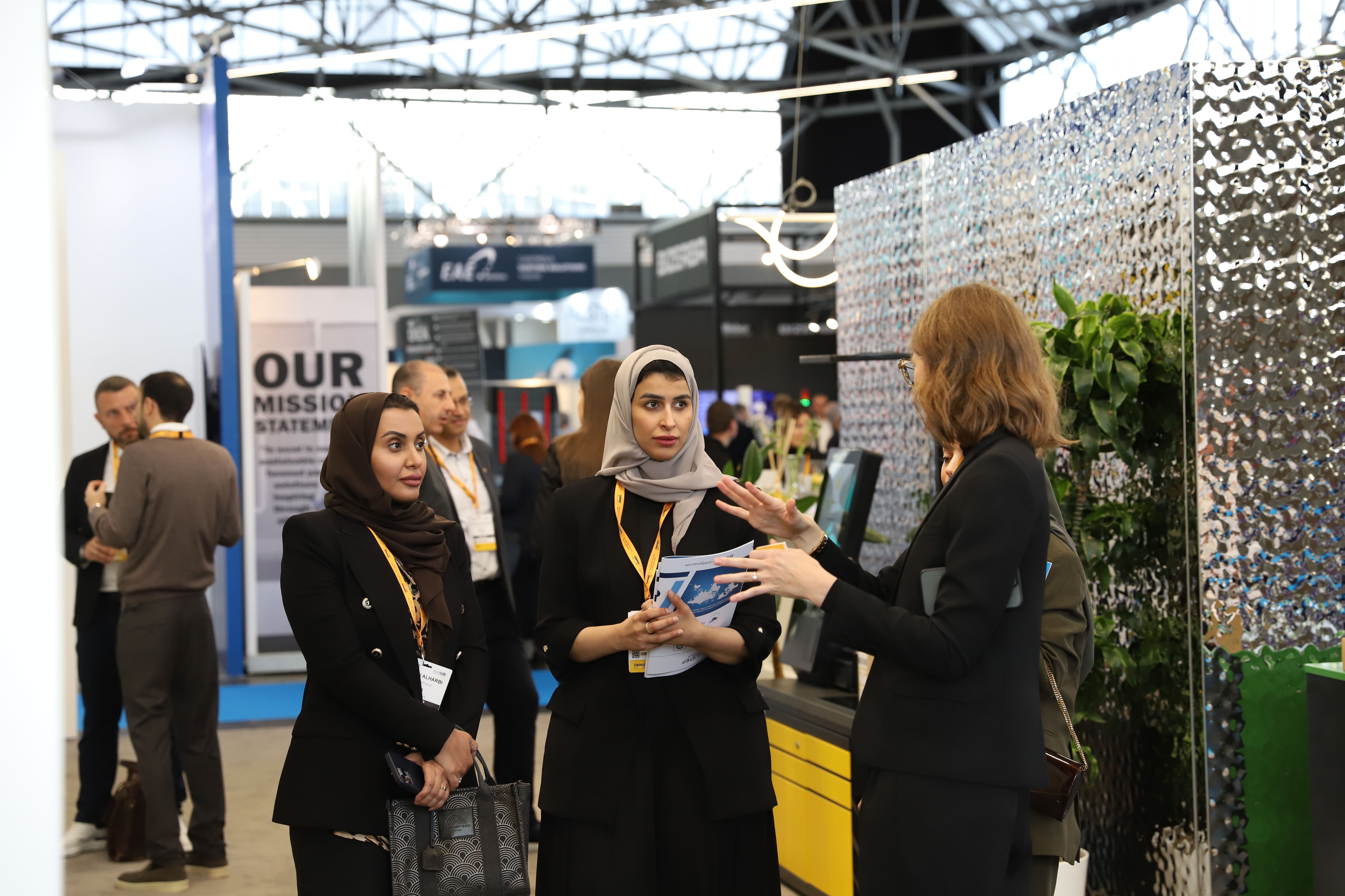 Photo shows people meeting at a booth at Parcel and Post Expo