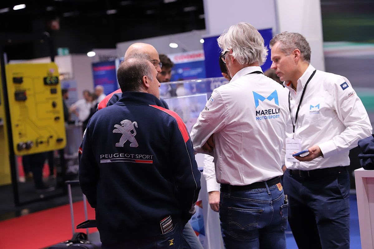 Exhibitor, Marelli networking with visitor, Peugeot Sport
