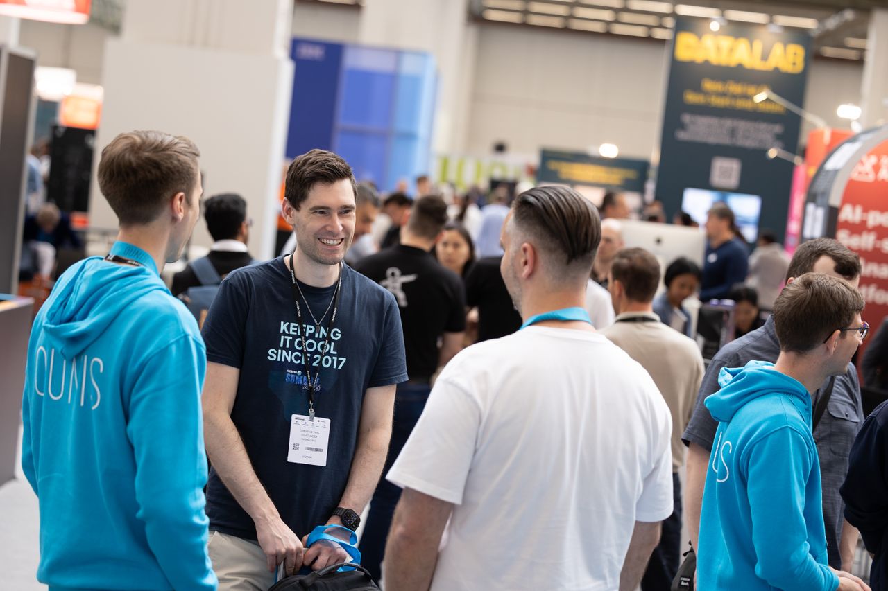 3 attendees networking and smiling 