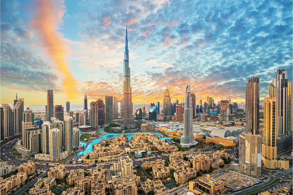 Panoramic skyline of Downtown Dubai featuring the Burj Khalifa at sunset.