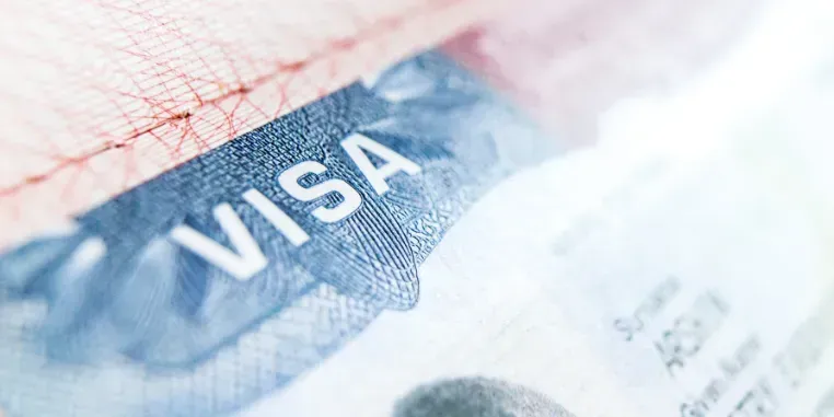 Close-up of a travel visa sticker stamped on a passport page.