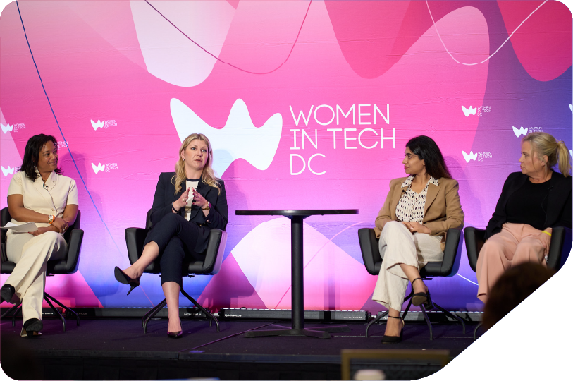 Panel of women in tech leaders talking on stage