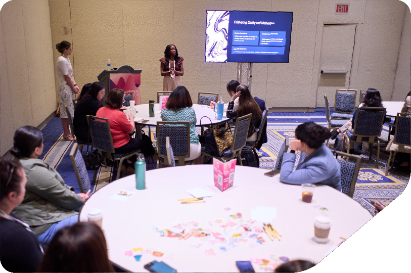 Image of a group of women writing down on a sheet of paper as part of a workshop activity