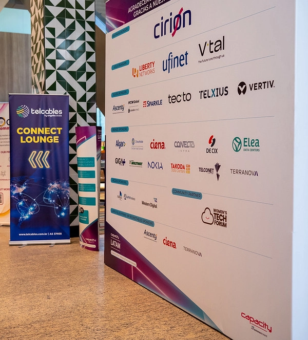 Capacity LATAM event venue showing sponsor wall display with Cirion, Liberty Networks, Ufinet, V.tal, and Telcables banners.