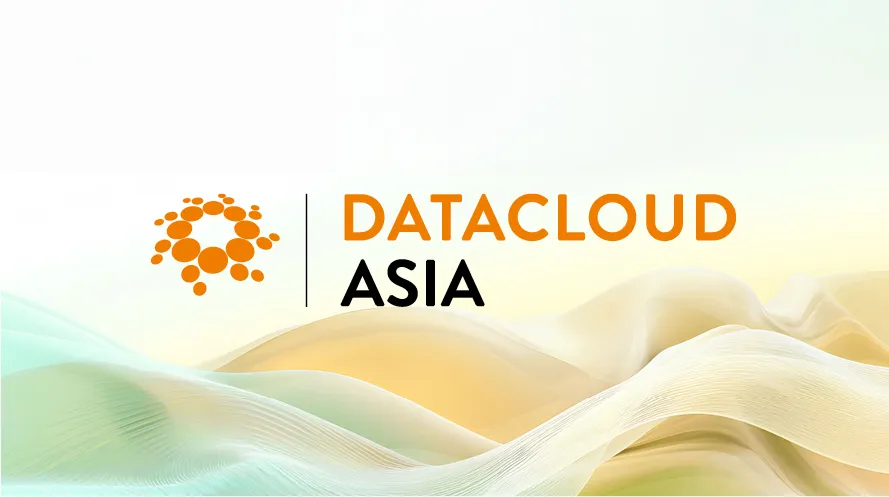 Event graphic for Datacloud Asia featuring a orange circular bubble logo alongside bold text reading 'DATACLOUD ASIA. Set against a background of flowing, light green and soft orange abstract waves.