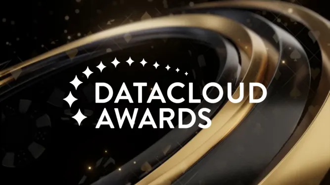 Graphic for the Datacloud Awards featuring white text that reads 'DATACLOUD AWARDS' alongside a crescent arch of four-pointed stars. Set against a dark, elegant background with metallic gold and dark gray curved concentric rings and subtle sparkling lights.