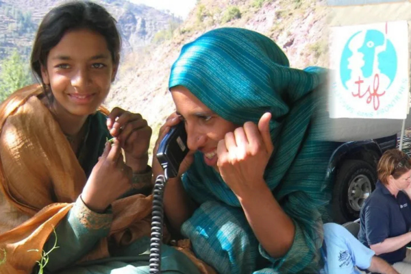 A wide panoramic composite image highlighting humanitarian aid and communication efforts by Telecoms Sans Fronti&egrave;res (TSF). The left section shows a smiling girl and a woman wearing a blue headscarf speaking on a satellite telephone outdoors. The middle section shows aid workers and local staff operating laptops on tables set up inside a large field tent beneath a TSF banner. The right section captures three children looking down intently together at a tablet enclosed in a case bearing the TSF logo.