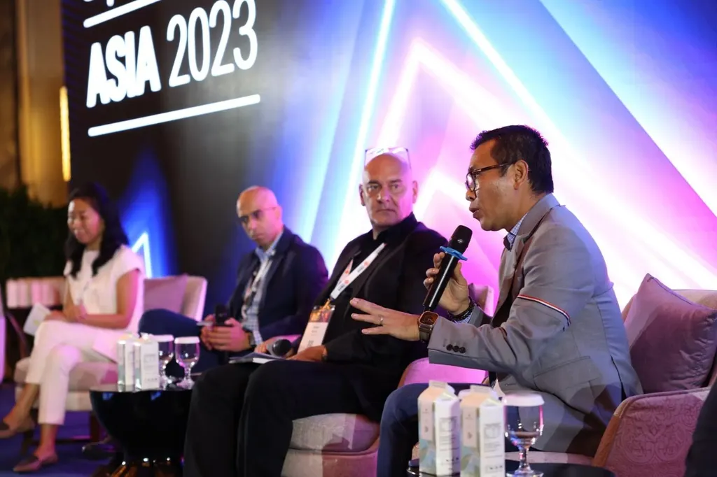 A panel discussion taking place on a stage at an event branded 