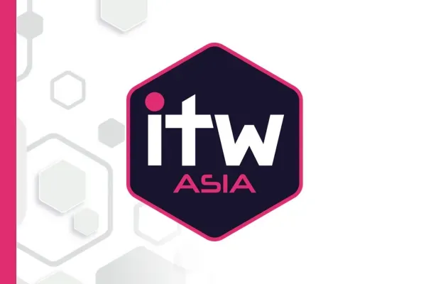 The corporate logo for ITW Asia. The logo features a dark blue hexagon with a bright pink border. Inside, the lowercase text 