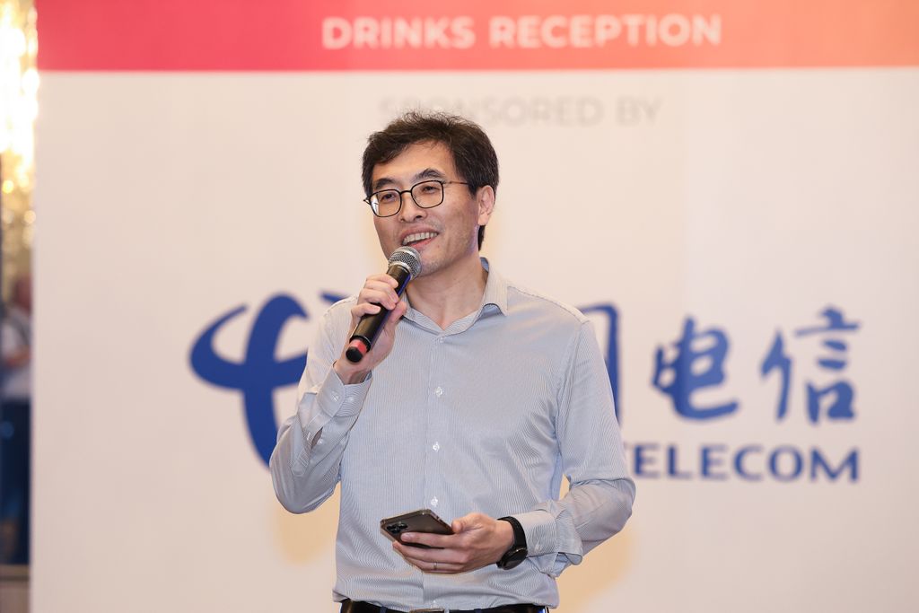 Speaker addressing attendees during a sponsored drinks reception