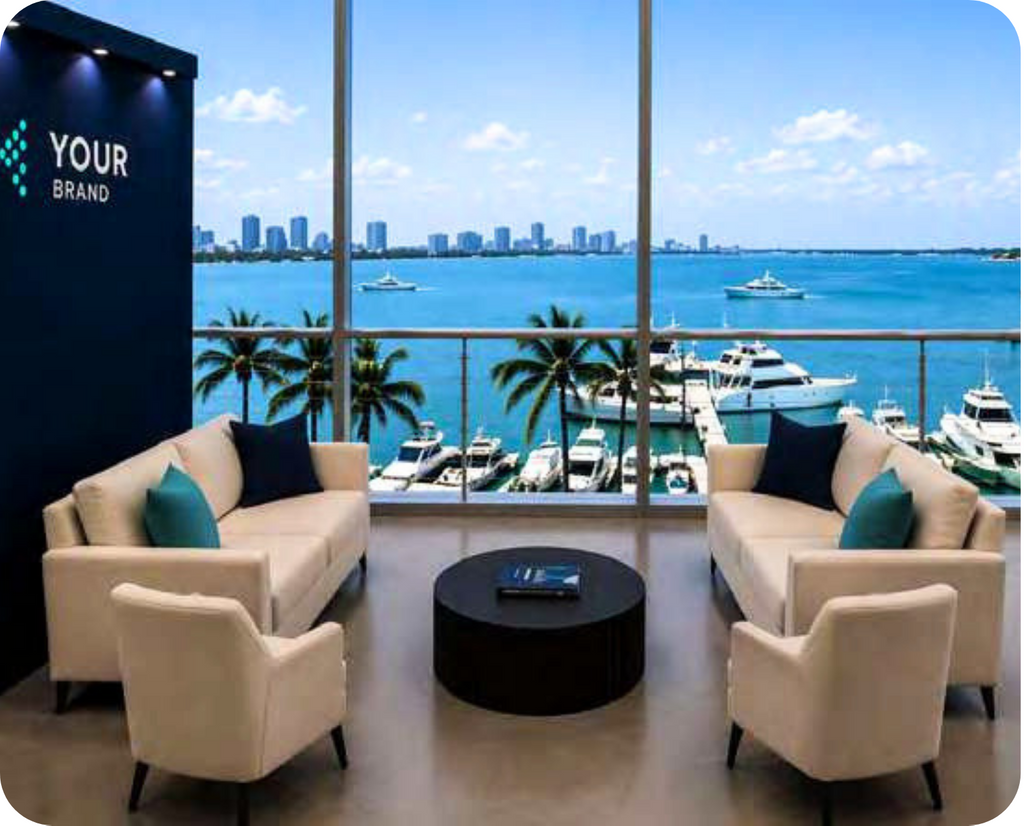 A meeting lounge with a large window in the background, with views onto the ocean and boats.