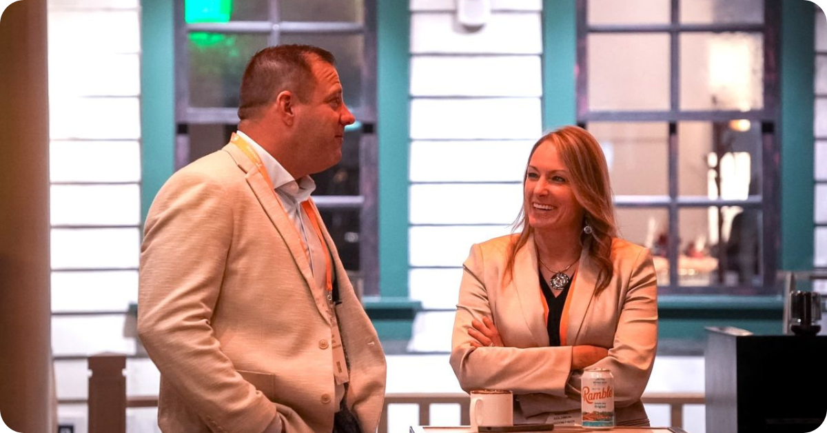 Two Metro Connect attendees having a conversation during the Fiber Leaders Lunch in an informal event setting.
