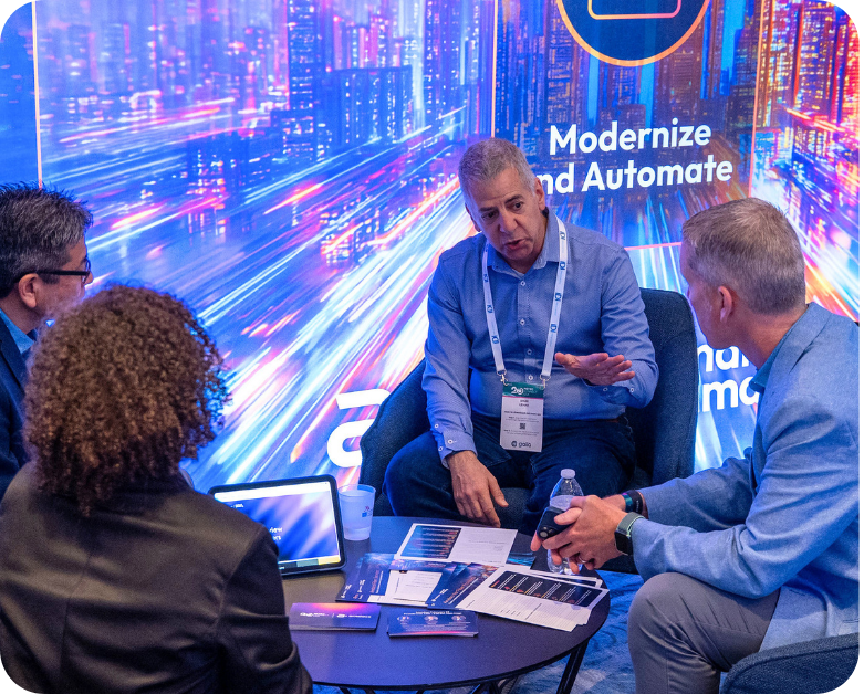 A group of professionals sitting at one of the branded meeting rooms at Metro Connect USA.