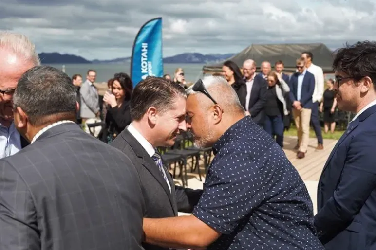 A hongi (Māori greeting) takes place between iwi artist Len Hetet and Transport Minister Michael Wood