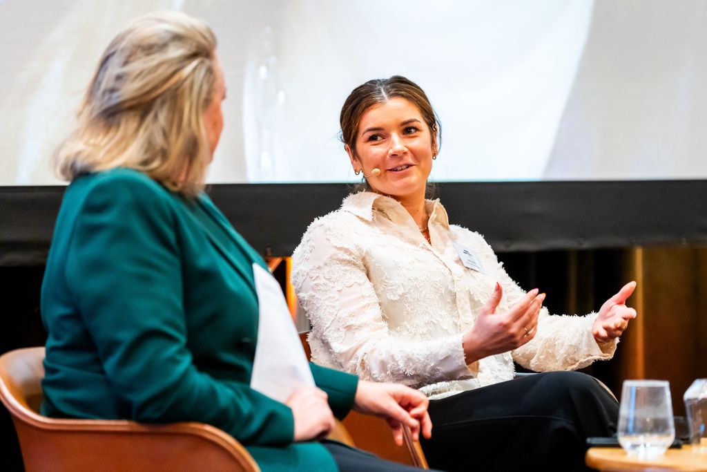 two women speaking on a panel
