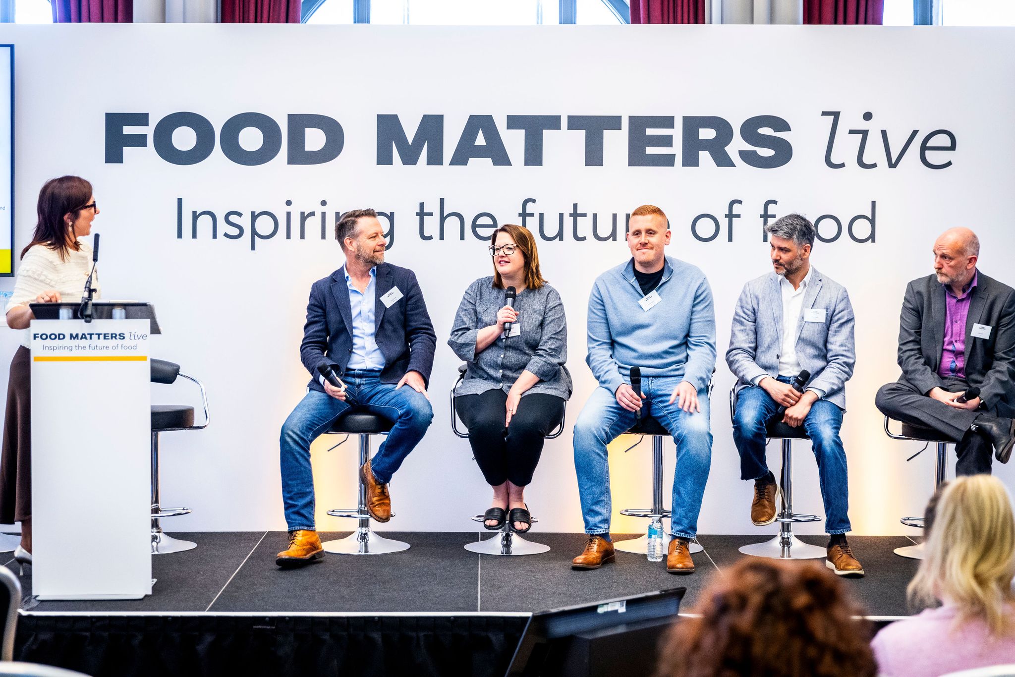 people on stage on a panel