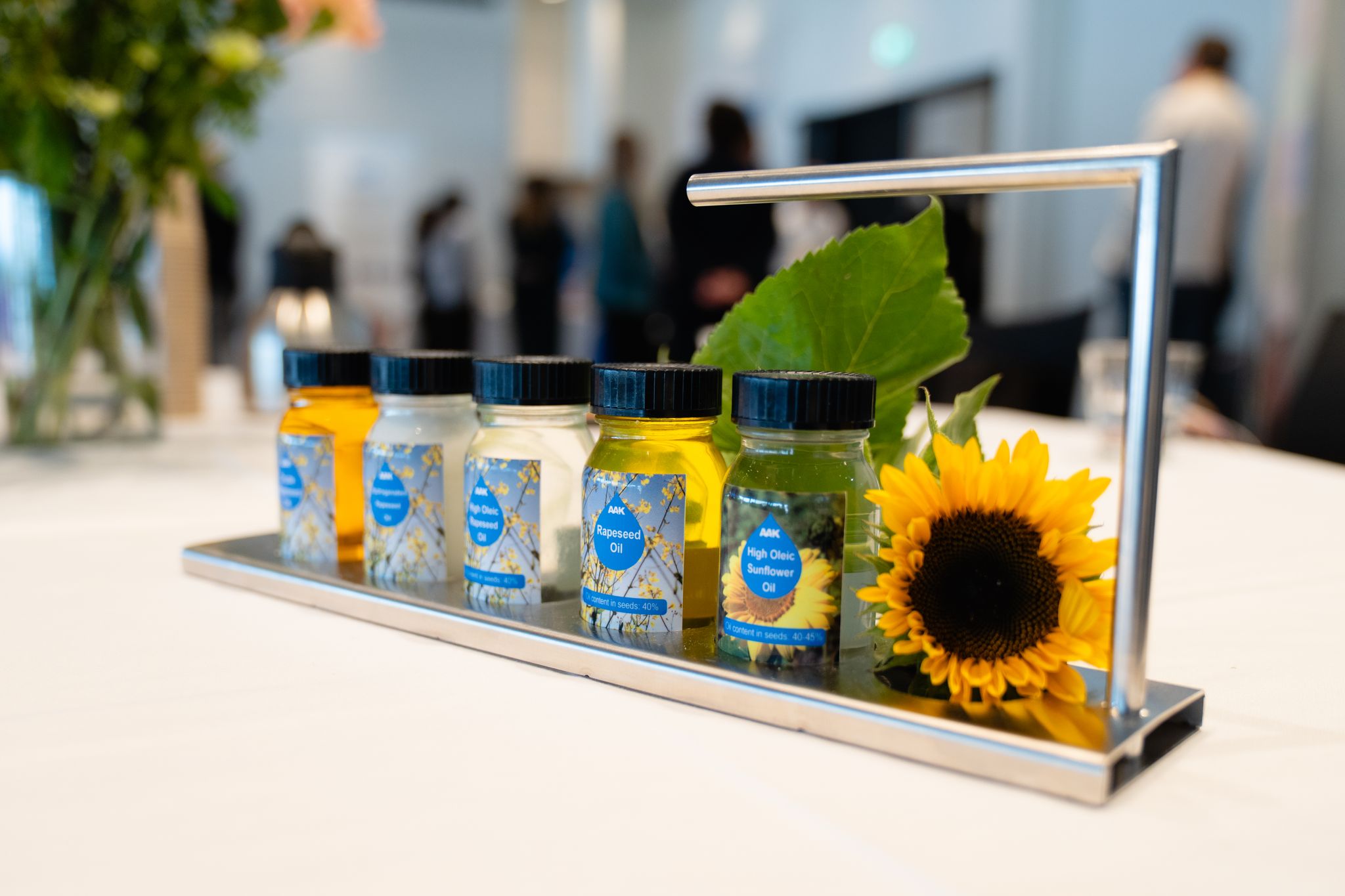 bottles on a table next to a sunflower