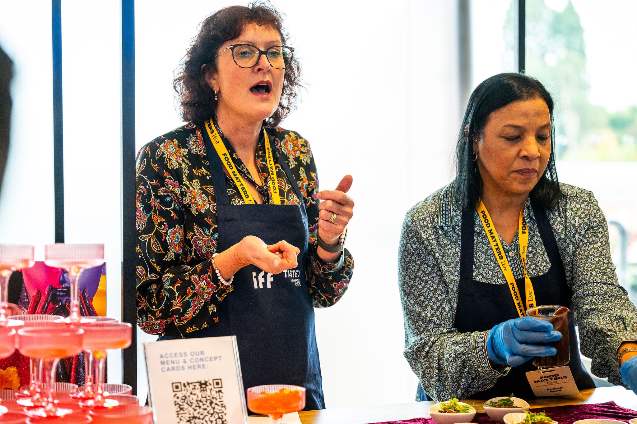 women at an event stand
