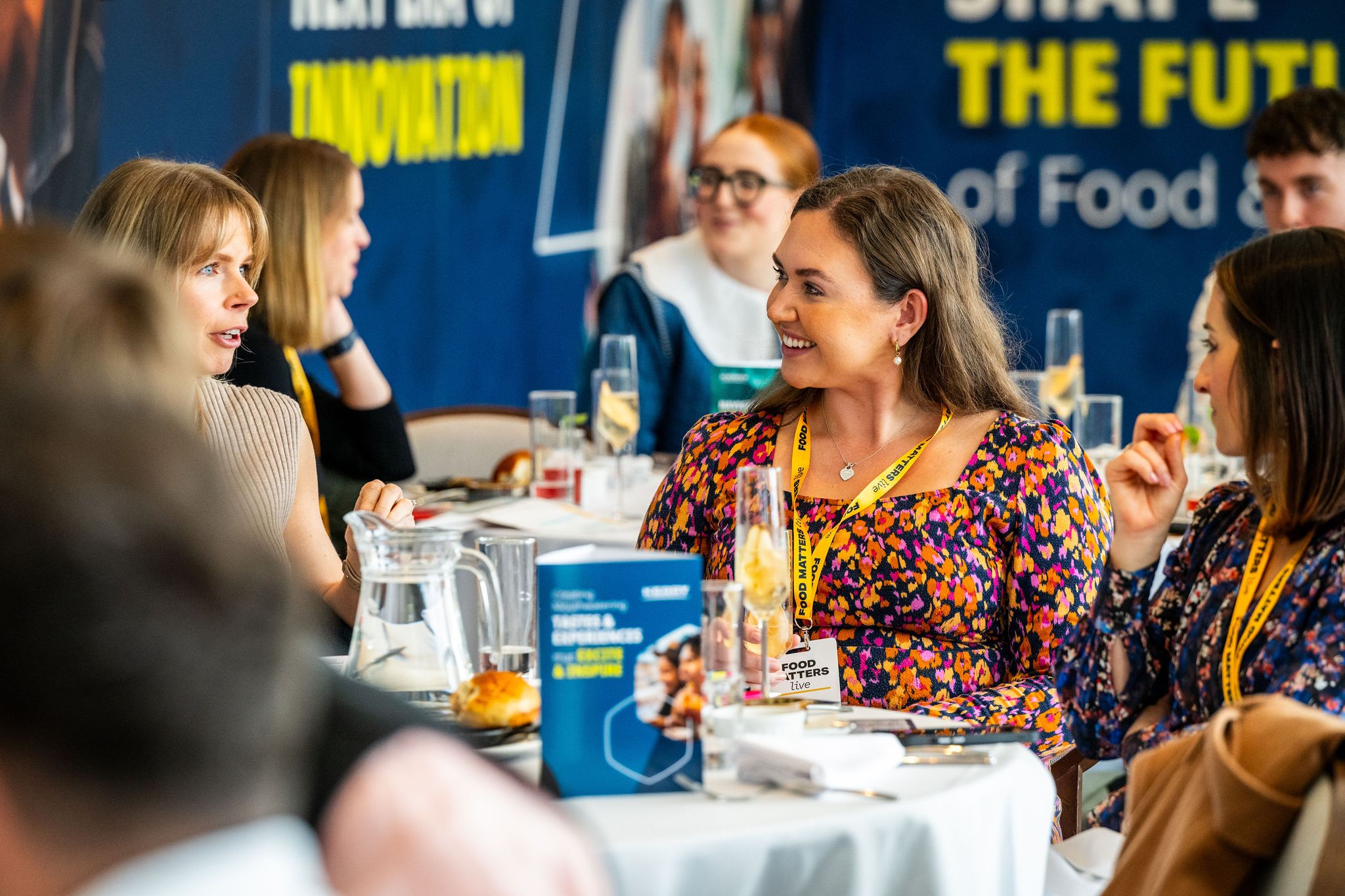 people at a table smiling and talking