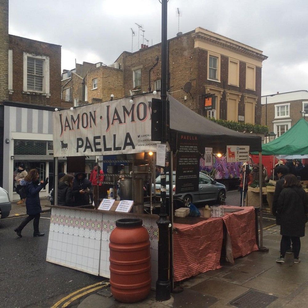 Jamon Jamon chefs posing at their street food stall in a busy London market