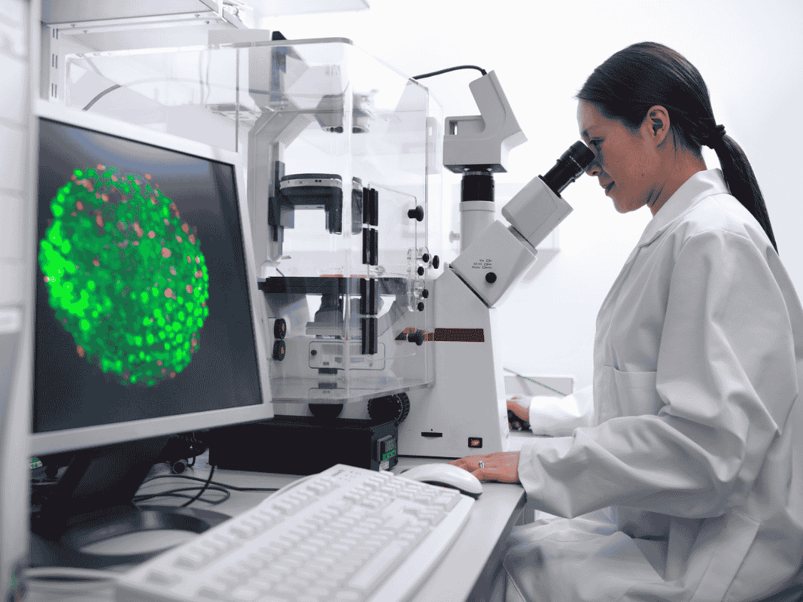 Image of female scientist at a microscope