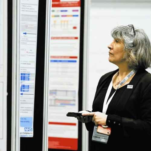 Lady looking at Poster Zone