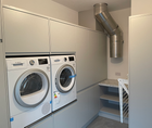 Laundry chutes and a central vacuum system