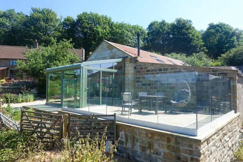 Barn conversion with glass extension and bi-folding doors in North York Moors national park